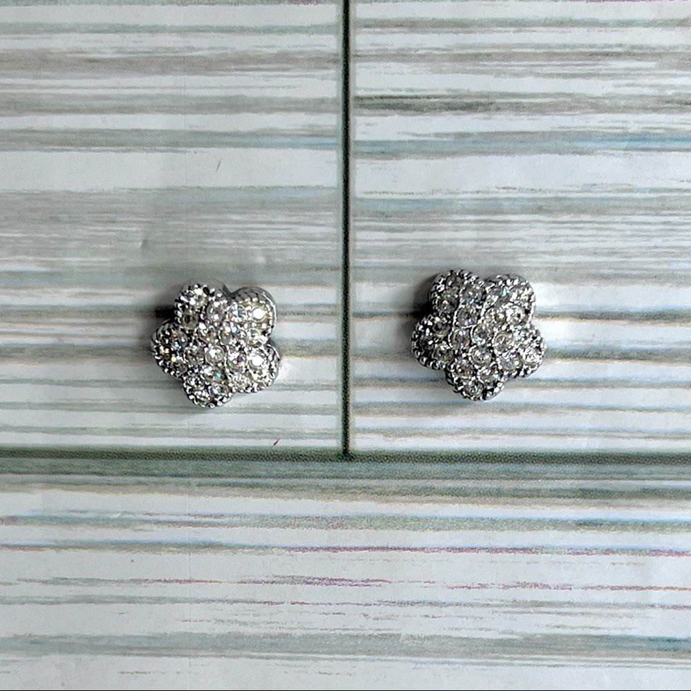 Silver tone flower pierced earrings in a pavé setting.